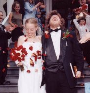 Jocelyn & Steve descend the stairs in a shower of bright flower petals