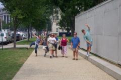 family group walking on the wide sidewalk