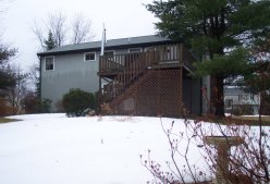 rear view of the house, with lots of snow in the back yard