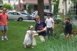 Hannah chases Phil who's carrying a football.