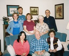 family posing around a sofa