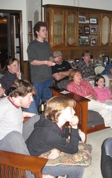 Kevin standing in the living room with seven onlookers