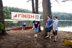 three guys with the finish banner