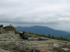 hiker poses in front of a mountain